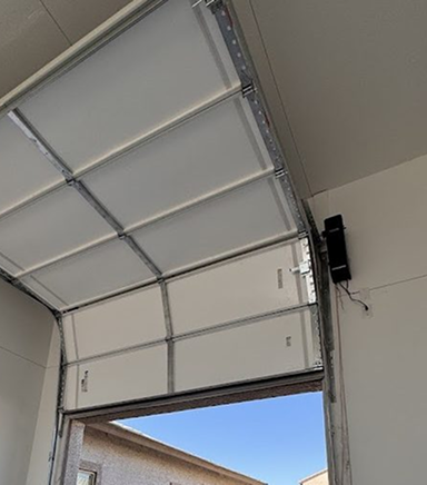 Close-up of a garage door spring replacement in progress.