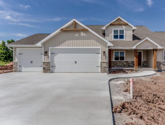 Modern residential home in Gilbert, AZ with a newly installed white garage door by Pride Garage Doors.