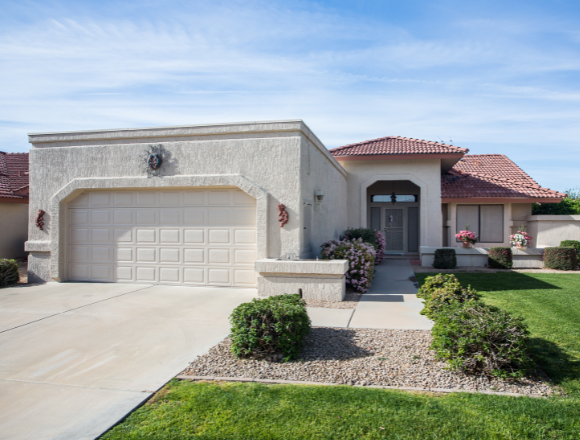 Modern home in Phoenix, AZ featuring a newly installed white garage door by Pride Garage Doors.